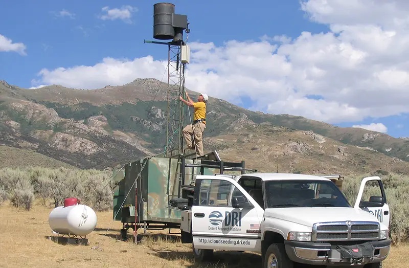 A DRI technician scales a ladder for a telecommunication tower.